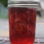 Up close view of a small mason jar of homemade strawberry jelly