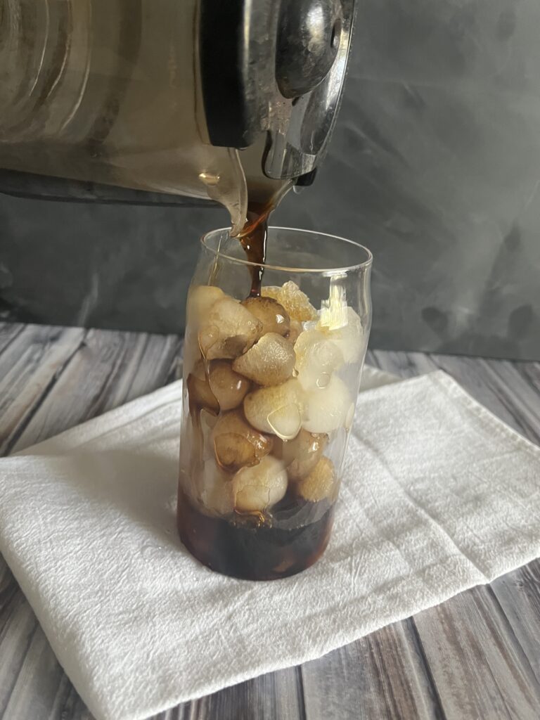 Image of pouring coffee into glass for iced coffee