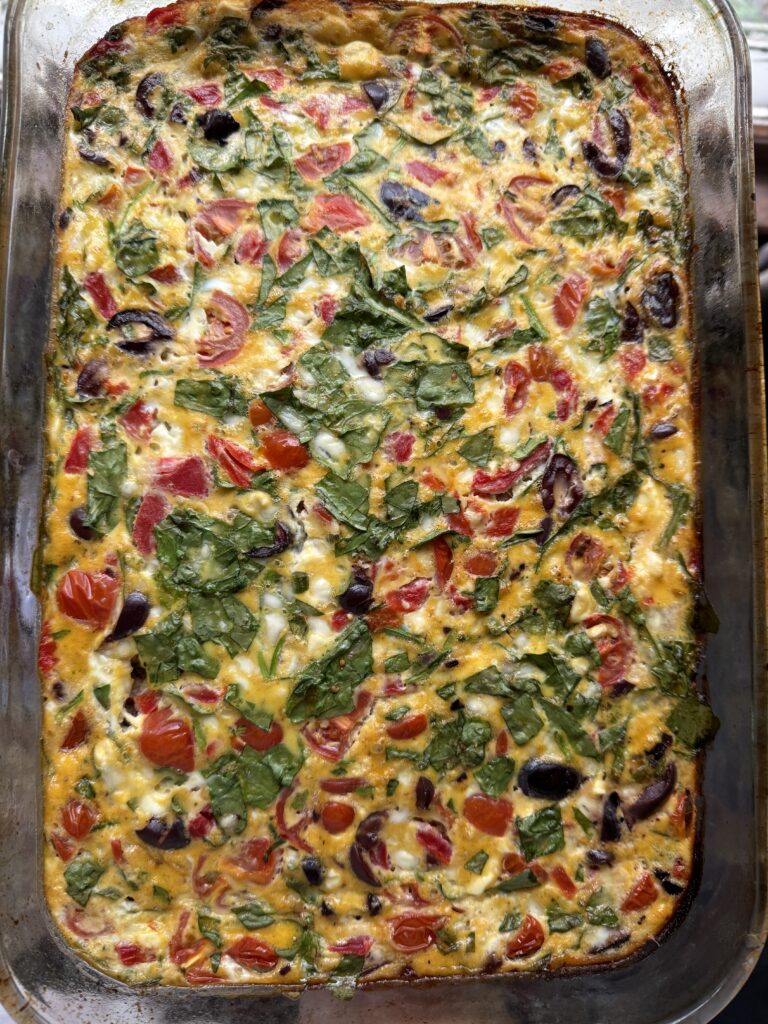 A veggie packed breakfast casserole in a 9x13 glass dish